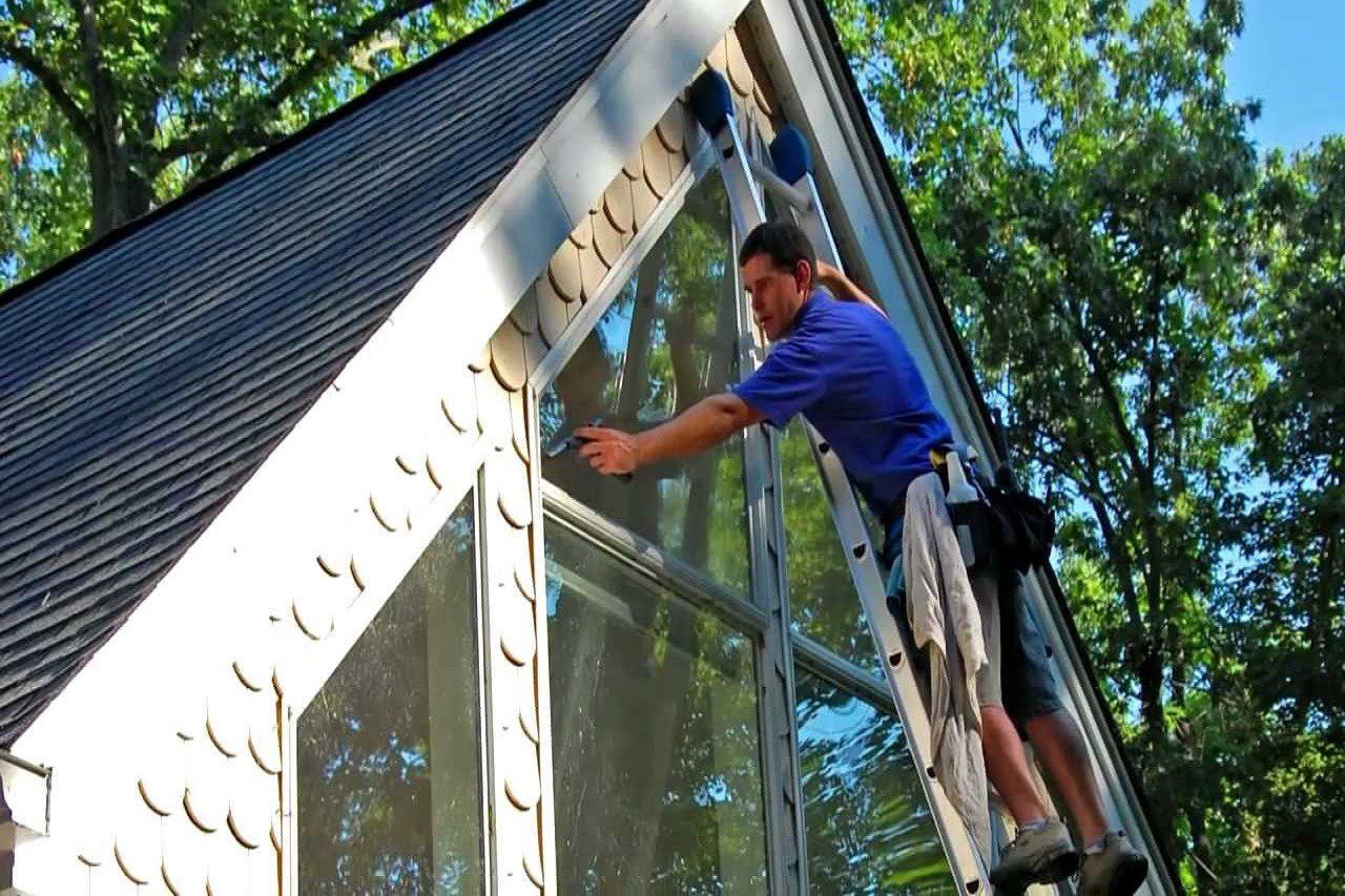 Cleaning windows with ladder
